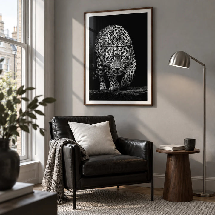 Black Leopard Wall Art, framed on the wall of a modern reading corner beside a tall window in a UK maisonette with a soft grey wall in a living room