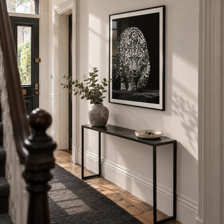 Black Leopard Wall Art, framed on the wall of a narrow entrance hallway in a Victorian UK terrace with a chalk-white wall and restored wooden floorboards