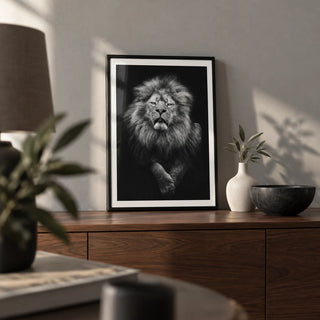Black Lion Art Print, a small A4 framed print leaning on a walnut sideboard in a living room