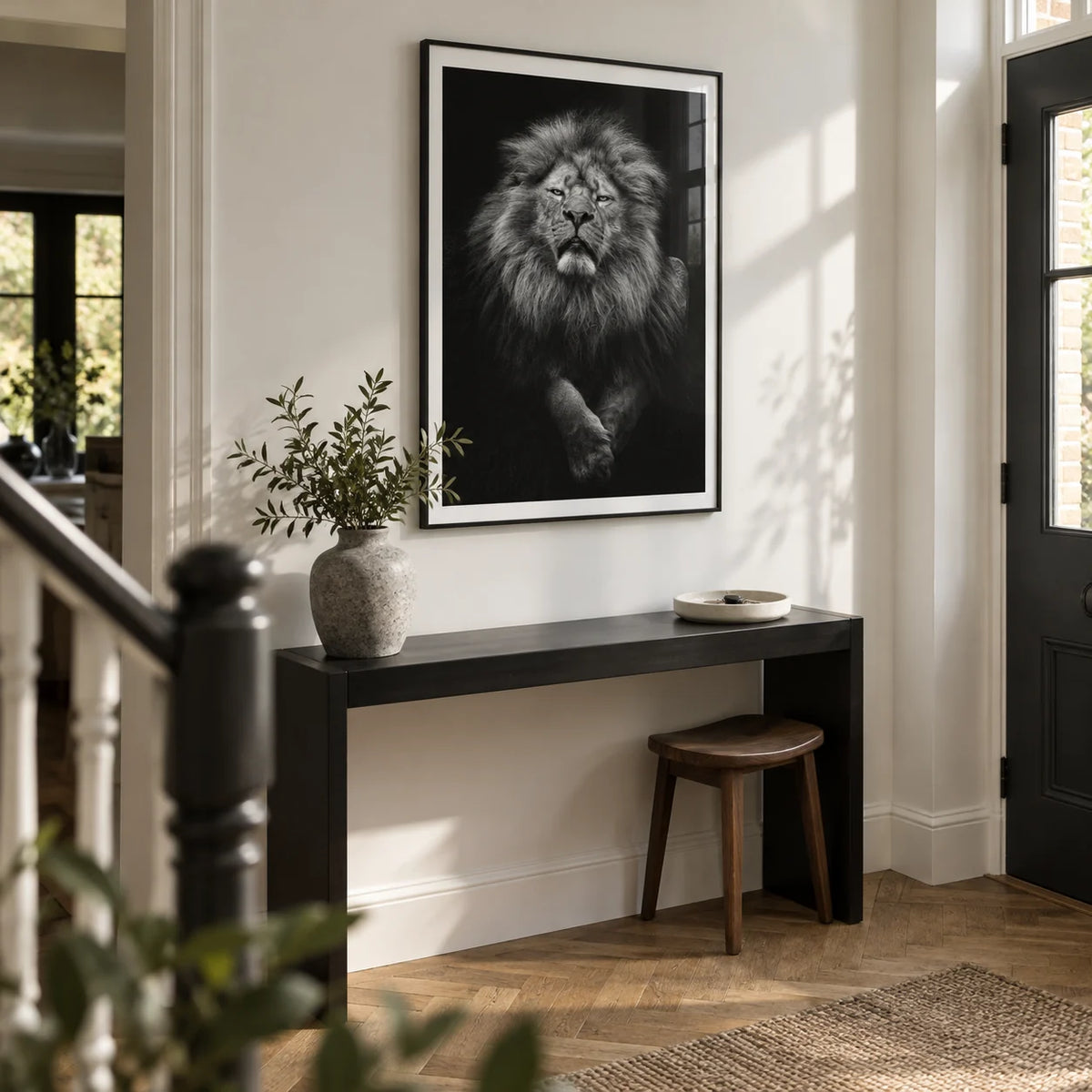 Black Lion Art Print, framed on the wall of a spacious entrance hallway in a renovated UK semi-detached house with a chalk white wall and oak parquet floor