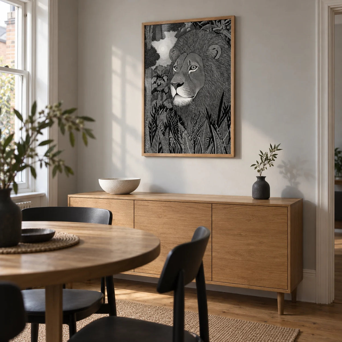 Black Lion Wall Art, framed on the wall of a compact modern dining room in a UK terrace with a pale grey wall and warm timber floor