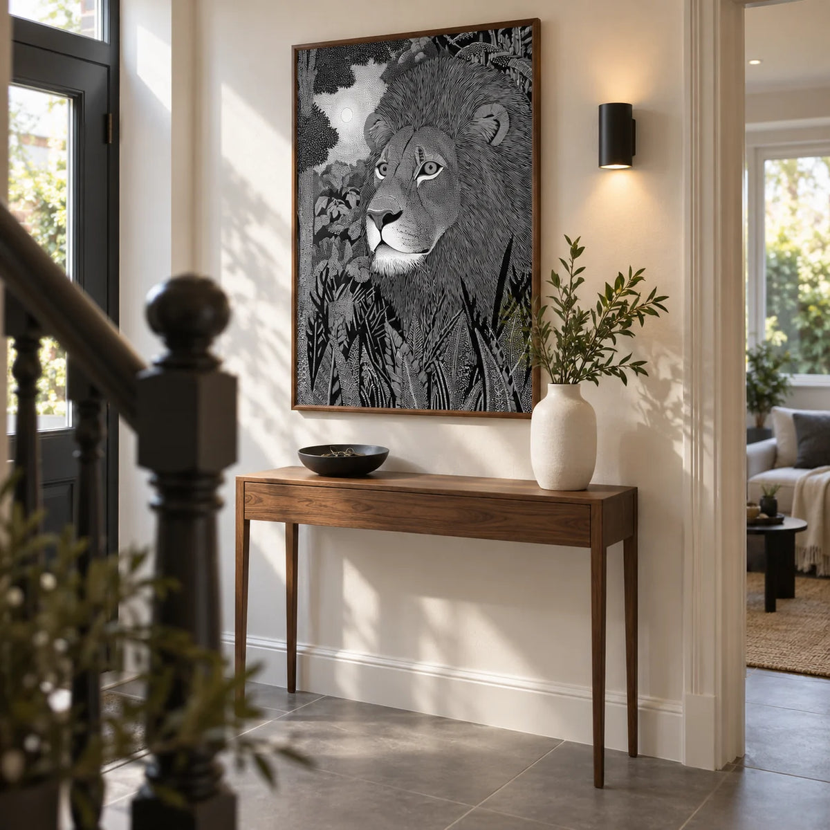 Black Lion Wall Art, framed on the wall of a welcoming hallway in a renovated UK terrace with a warm white wall and large plain grey floor tiles