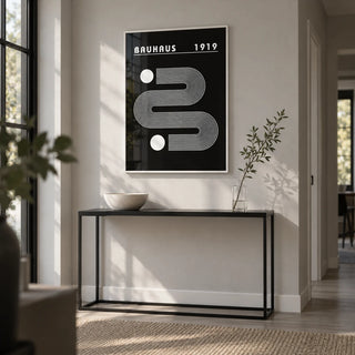 Black Minimalist Art, framed on the wall of a modern hallway with a pale grey wall