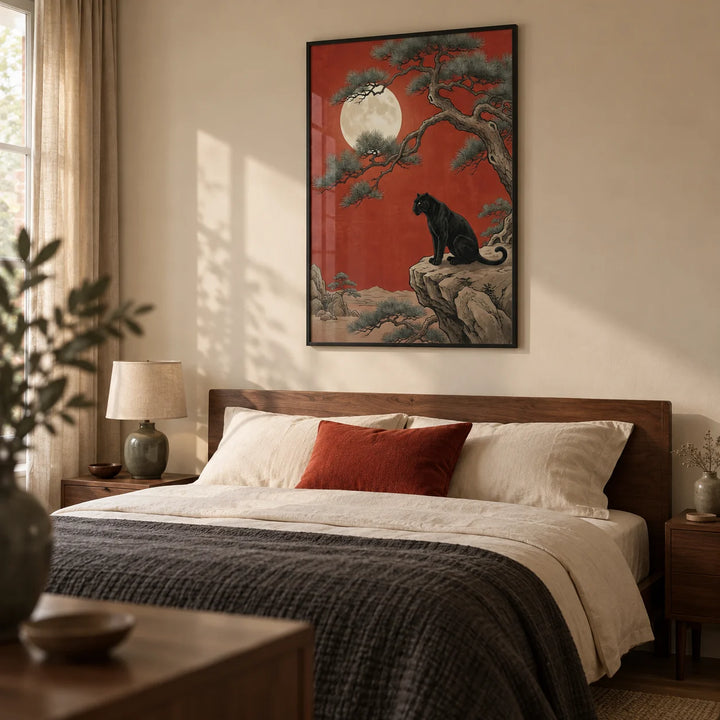 Black Panther Moon Print, framed on the wall of a calm adult bedroom in a UK home with a warm cream wall and low walnut furniture
