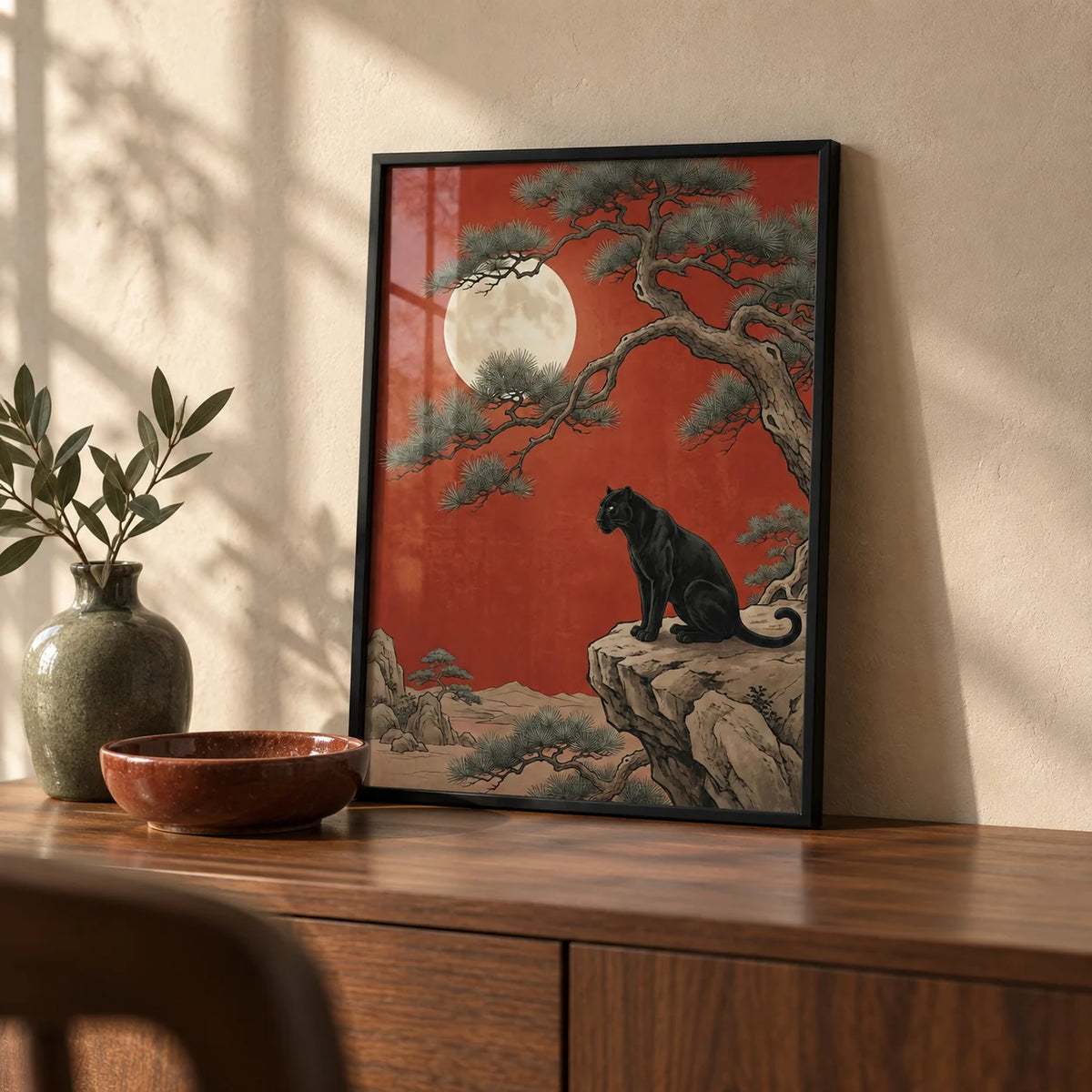 Black Panther Moon Print, a small A4 framed print leaning on a walnut sideboard in a living room