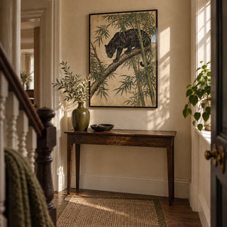 Black Panther Wall Art, framed on the wall of a characterful narrow hallway in a UK townhouse with warm cream plaster walls