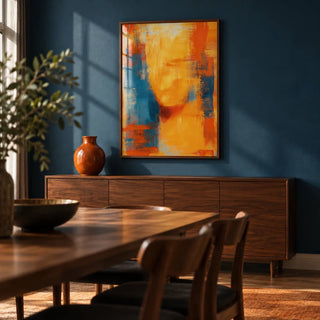 Blue and Orange Abstract Art, framed on the wall of a moody dining room with a deep blue painted wall