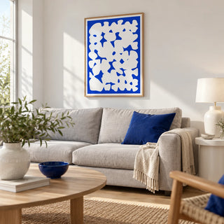 Blue And White Modern Art, framed on the wall of a bright modern living room