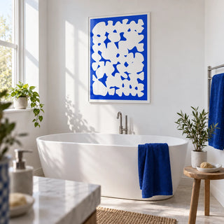 Blue And White Modern Art, framed on the wall of a modern white bathroom