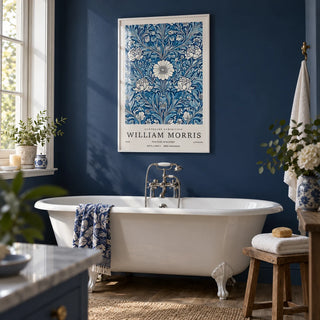 Blue Botanical Prints, framed on the wall of a calm bathroom with a navy painted wall and a white roll-top bath