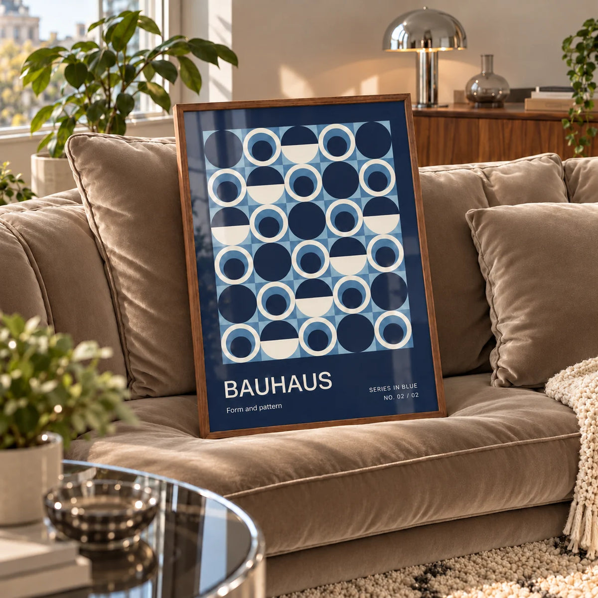 Blue Circles Wall Art, a framed print leaning on a velvet sofa in a living room