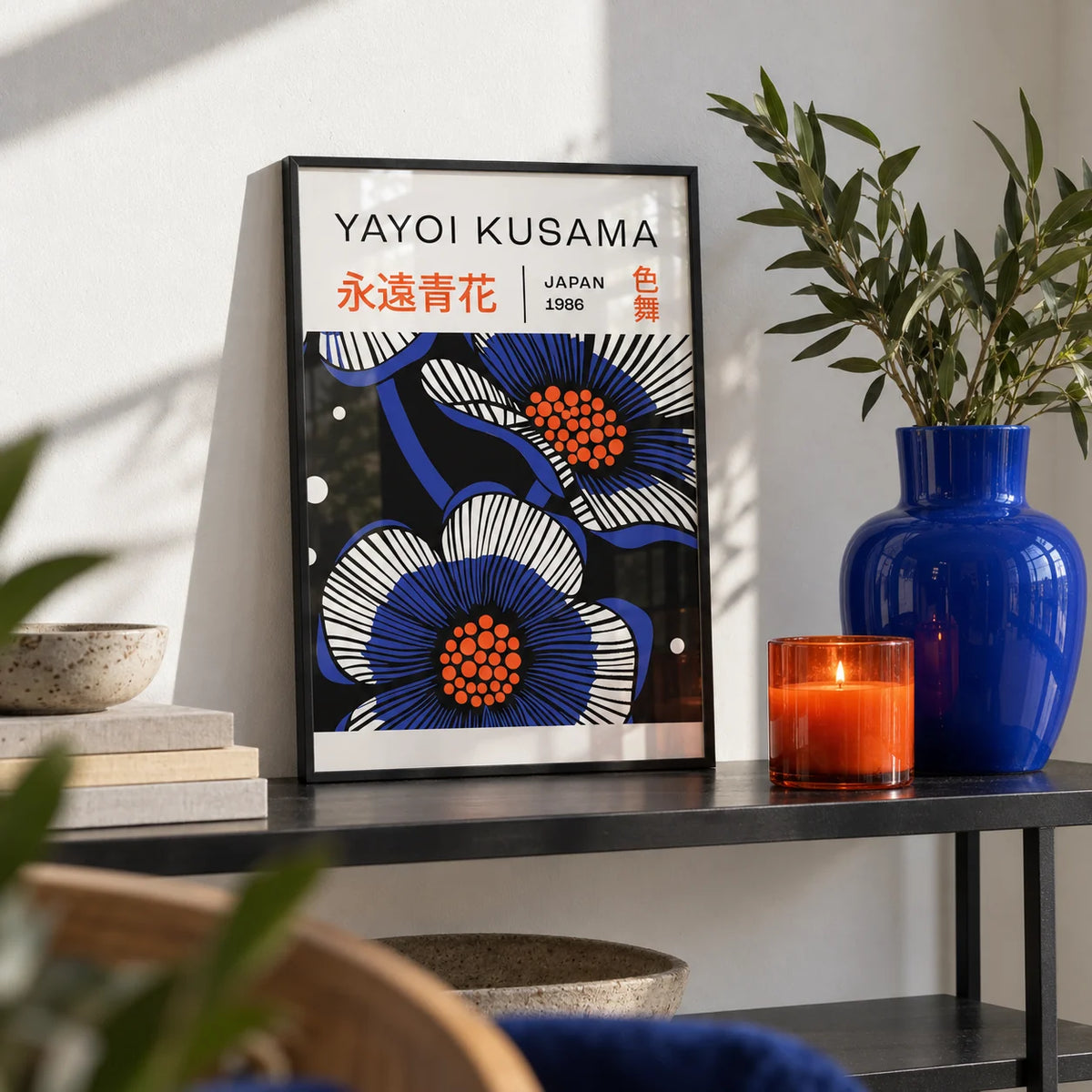 Blue Flower Poster, a small A4 framed print leaning on a black metal shelf in a living room