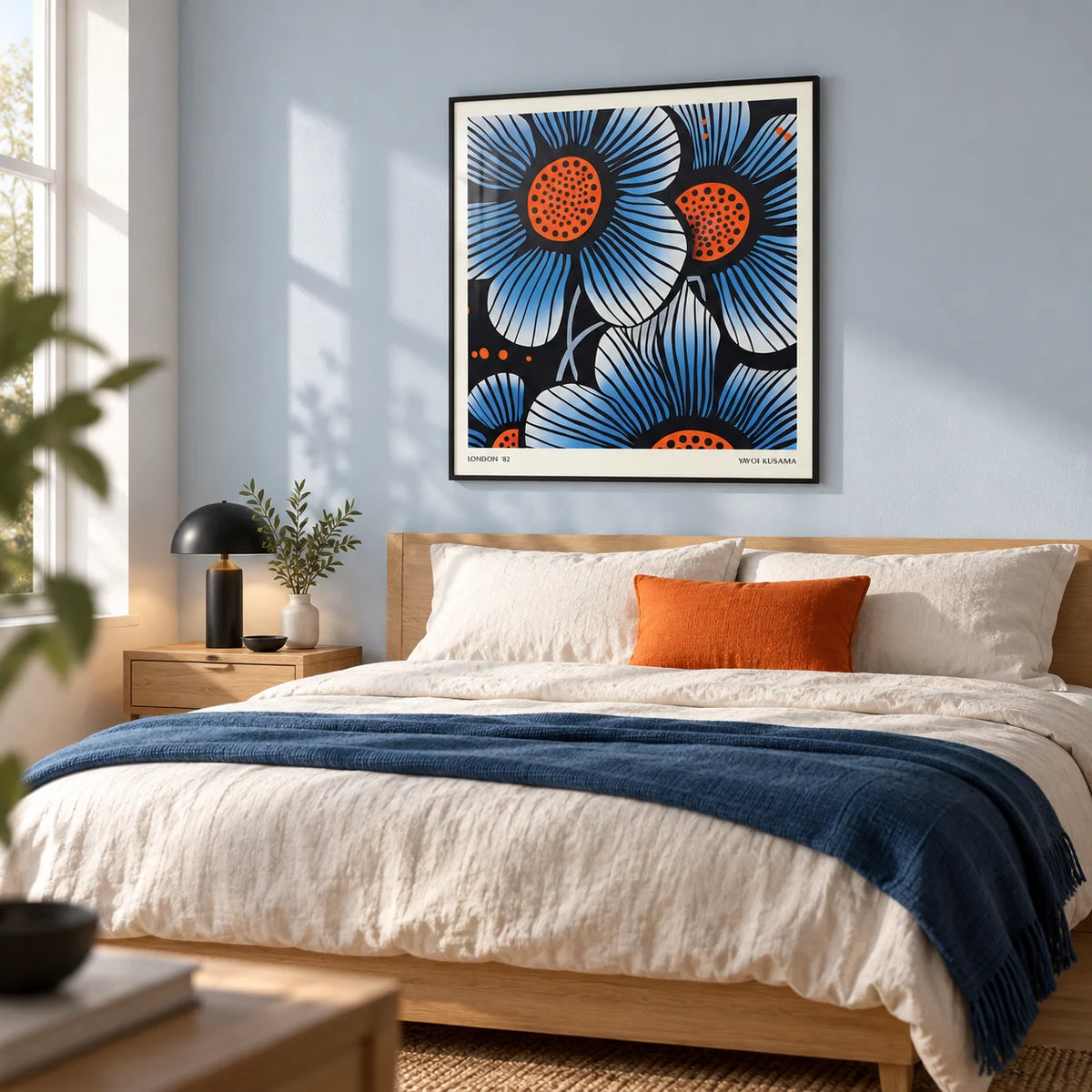 Blue Flower Wall Art, framed on the wall of a crisp modern bedroom with a pale blue wall and a light oak floor
