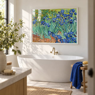 Blue Iris Wall Art, framed on the wall of a bright bathroom with white walls and a plain pale stone floor
