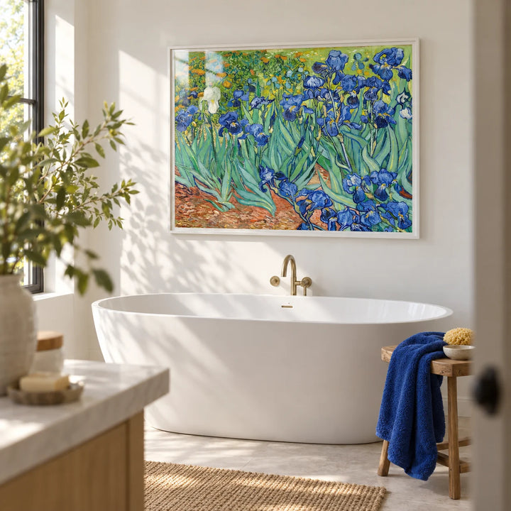 Blue Iris Wall Art, framed on the wall of a bright bathroom with white walls and a plain pale stone floor