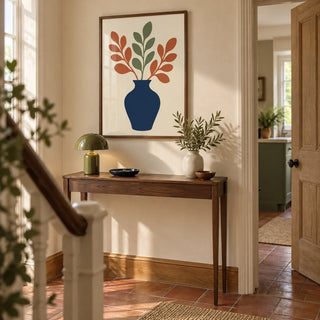 Blue Vase Print, framed on the wall of a welcoming hallway in a renovated UK terrace with cream plaster walls and a simple terracotta tiled floor