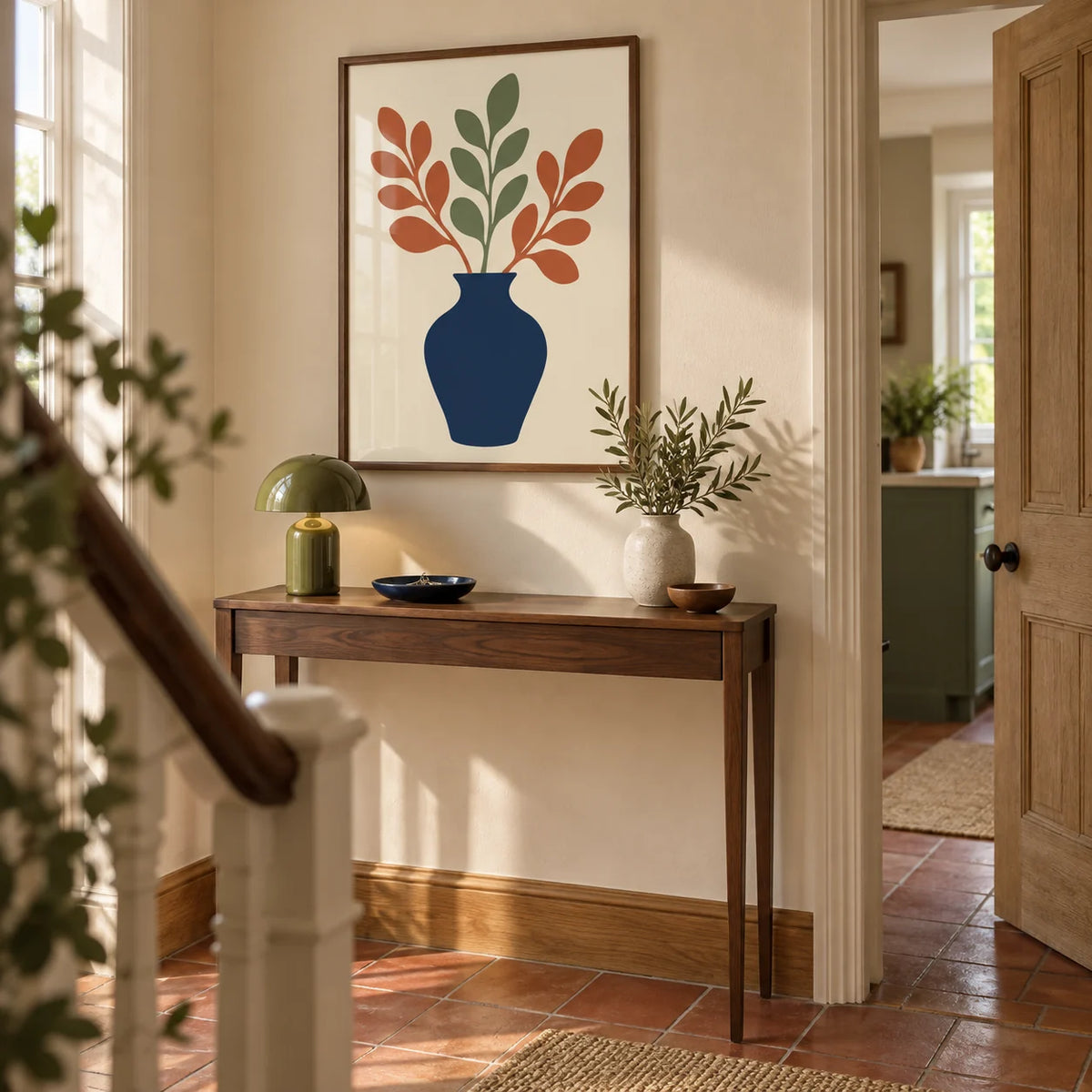 Blue Vase Print, framed on the wall of a welcoming hallway in a renovated UK terrace with cream plaster walls and a simple terracotta tiled floor
