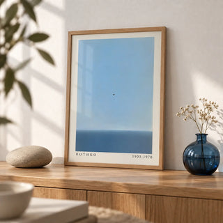 Blue Wall Art, a small A4 framed print leaning on an oak shelf in a living room