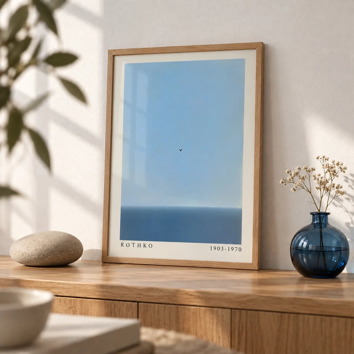 Blue Wall Art, a small A4 framed print leaning on an oak shelf in a living room