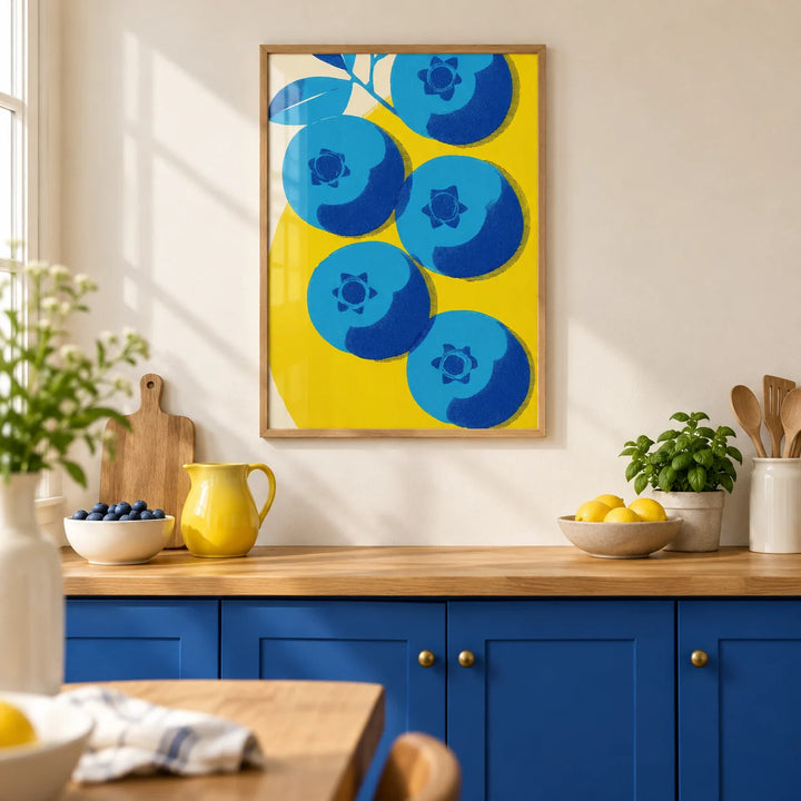 Blueberry Wall Art, framed on the wall of a bright modern kitchen with a cream wall and solid cobalt blue painted cabinets
