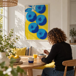 Blueberry Wall Art, framed on the wall of a sunny breakfast nook with a white wall in a kitchen
