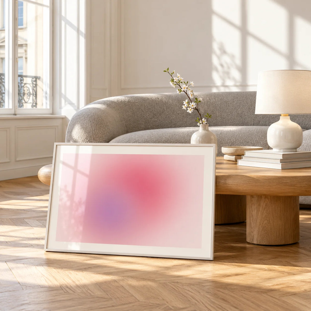 Blush Wall Art, framed and leaning against a coffee table in a bright living room