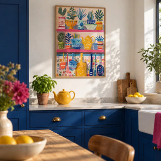 Boho Kitchen Print, framed on the wall of a modern kitchen with solid cobalt blue cabinets and a plain white wall