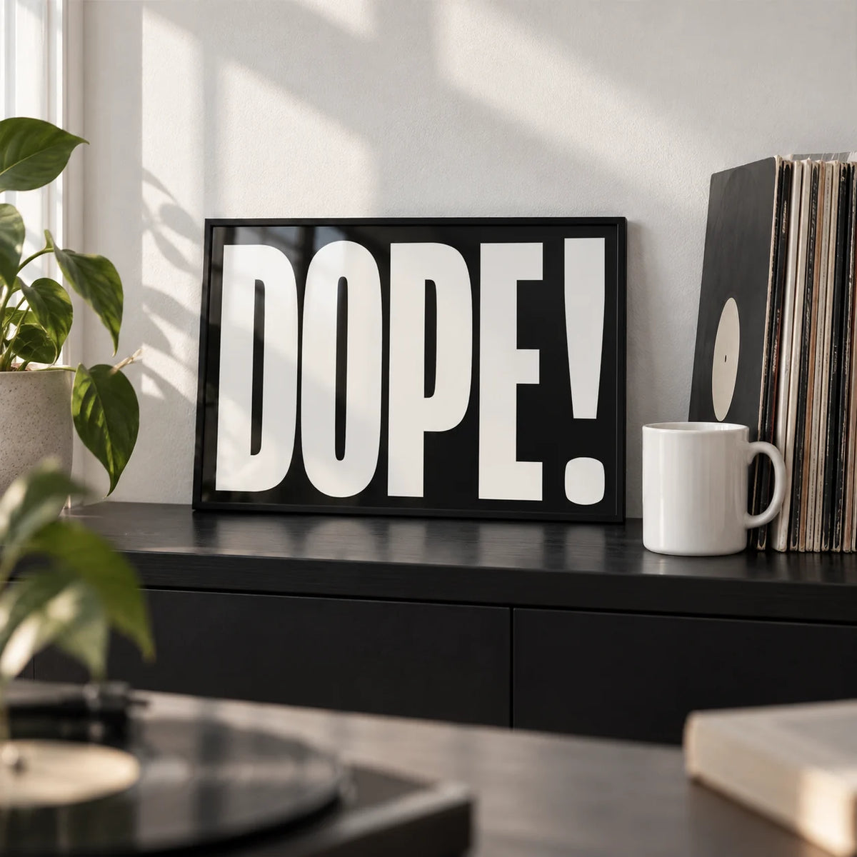 Bold Font Poster, a small A4 framed print leaning on a black shelf in a living room