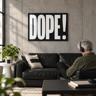Bold Font Poster, framed on the wall of a young man's city flat living room (22-30) with a concrete wall