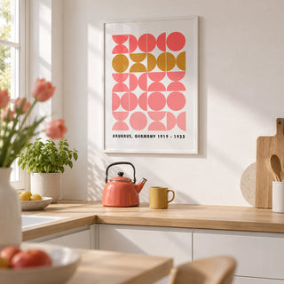 Bold MCM Wall Art, framed on the wall of a modern white kitchen with a plain white wall and pale oak worktops