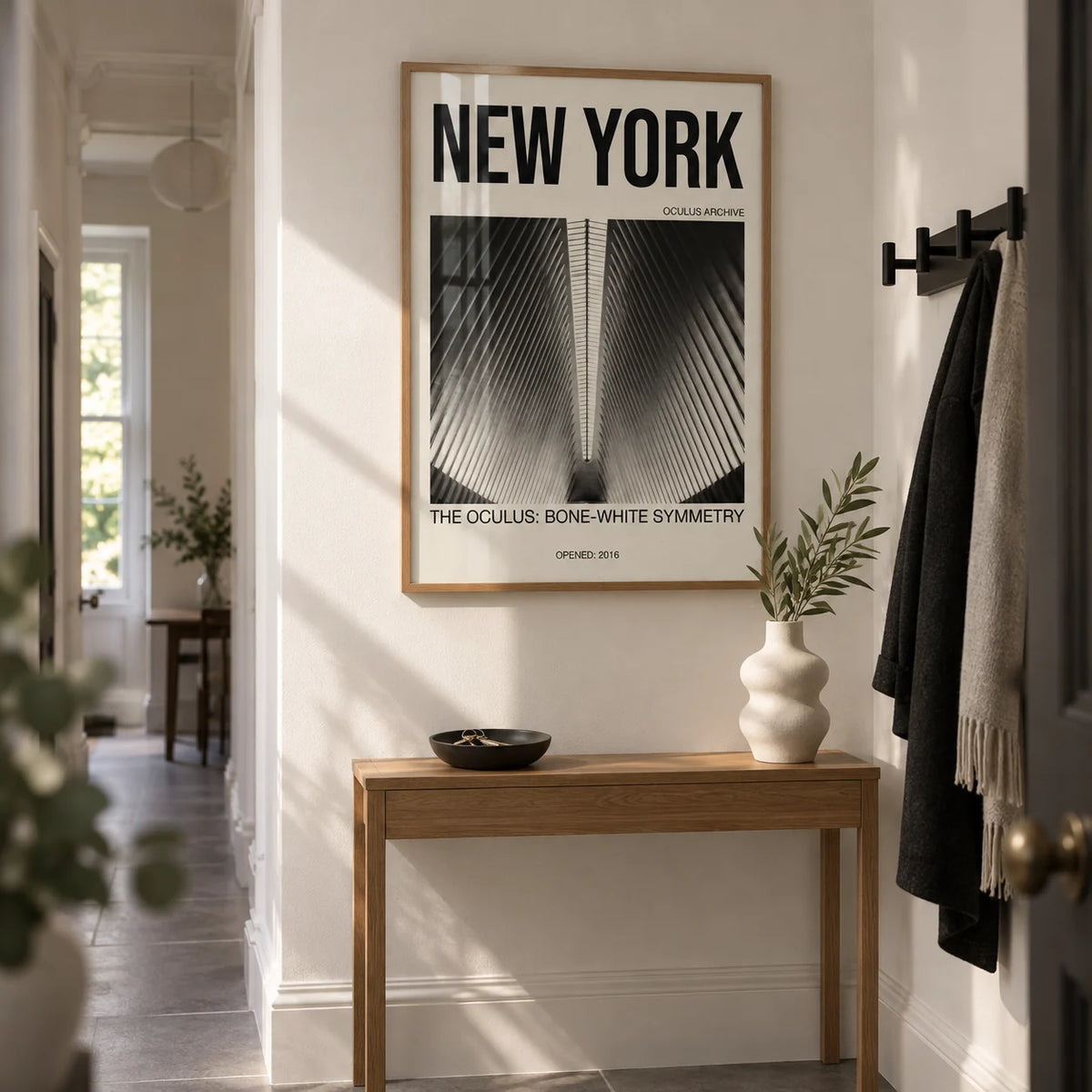 Bone White Architecture Print, framed on the wall of a narrow hallway in a renovated Victorian terrace with bone-white walls and large plain grey floor tiles