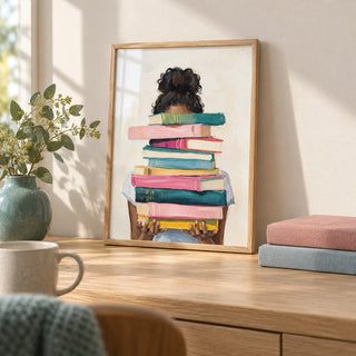 Book Lover Art Print, a small A4 framed print leaning on a pale oak desk
