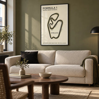 Brazilian Race Circuit Poster, framed on the wall of a design-led living room in a UK city flat with an olive painted wall and pale oak floor
