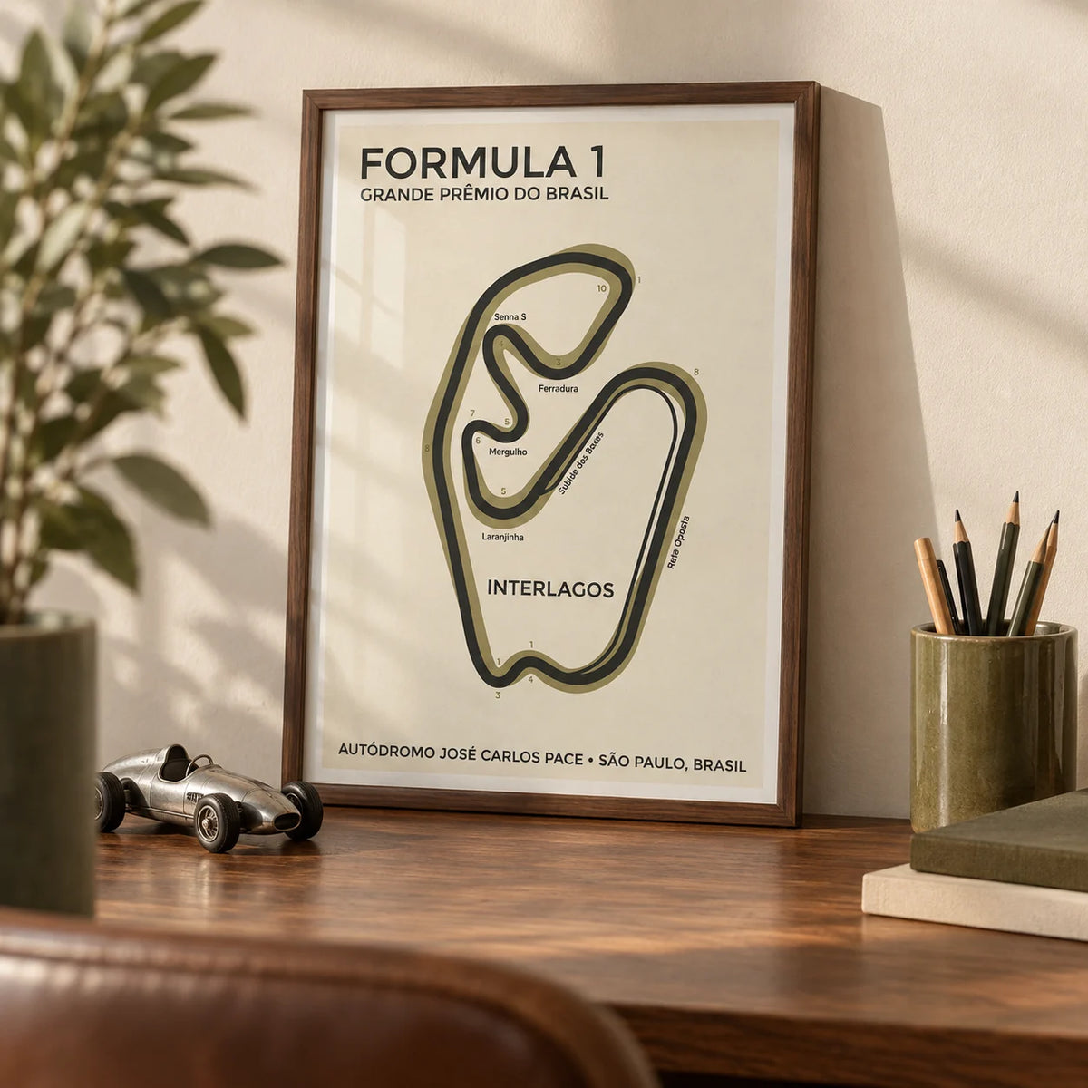 Brazilian Race Circuit Poster, a small A4 framed print leaning on a walnut desk