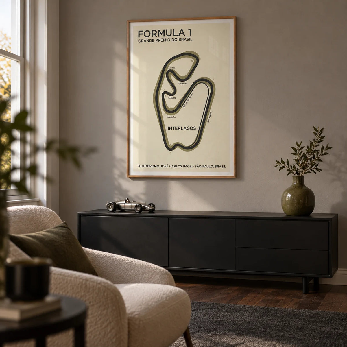 Brazilian Race Circuit Poster, framed on the wall of a small racing fan's snug in a UK terraced house with a warm grey wall and dark wood floor in a living room