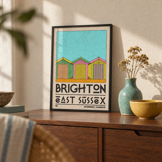 Brighton Travel Print, a small A4 framed print leaning on a walnut sideboard in a living room