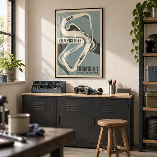British Race Track Map Poster, framed on the wall of a clean converted garage hobby room in a British semi-detached home with a warm off-white plaster wall and sealed concrete floor