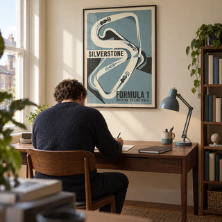 British Race Track Map Poster, framed on the wall of a motorsport enthusiast's home study in a UK terraced house with a warm cream wall