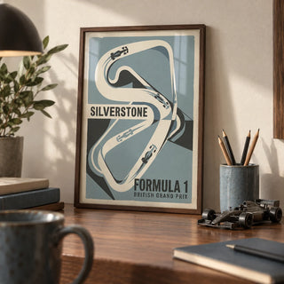 British Race Track Map Poster, a small A4 framed print leaning on a walnut desk