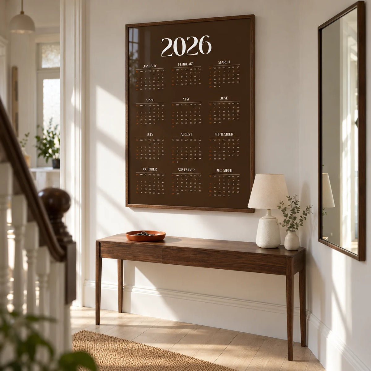 Brown Calendar Print, framed on the wall of a crisp hallway in a renovated UK terraced house with a white wall and pale timber floor