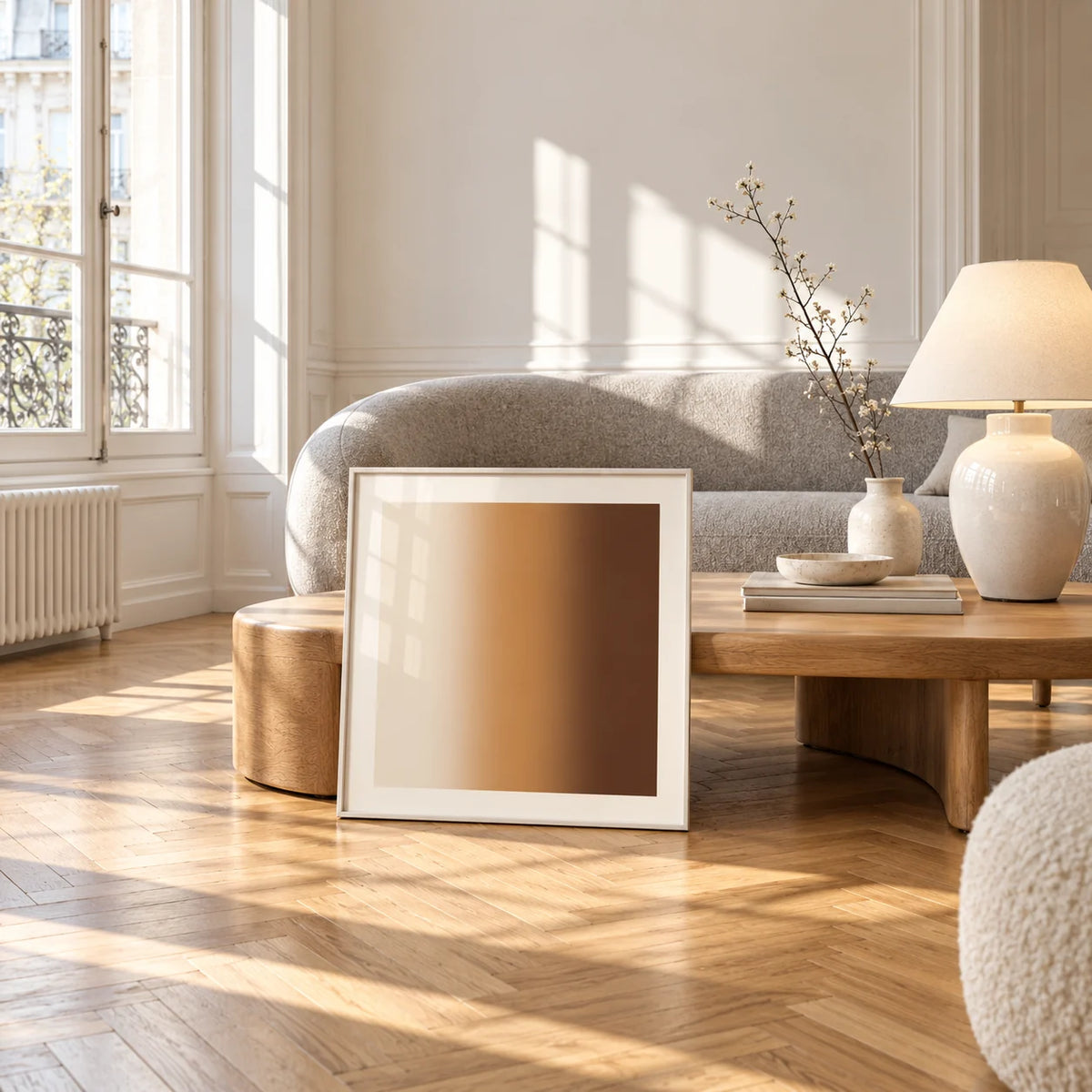 Brown Wall Art, framed and leaning against a coffee table in a bright living room