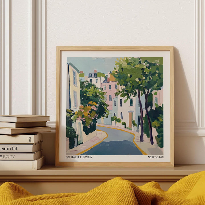 Notting Hill Poster framed print close-up of a street scene in pastel colours with trees and buildings above stacked books