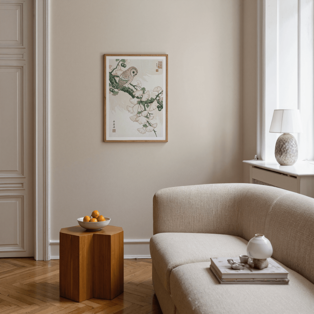 Living room with beige sofa, wooden side table, and framed artwork on the wall.