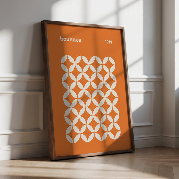 Orange poster with cream Bauhaus-style circle pattern and bold 1919 typography.