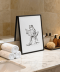 Ink-style frog with wide eyes reading a book wall art print