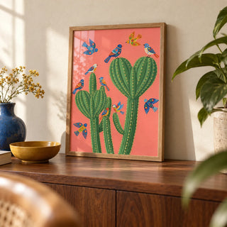 Cactus Poster Print, a small A4 framed print leaning on a walnut sideboard in a living room