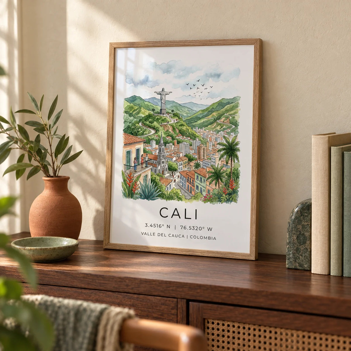 Cali Colombia Poster, a small A4 framed print leaning on a walnut study shelf