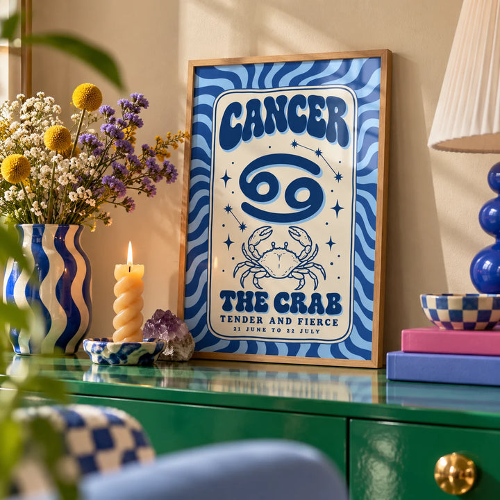 Cancer Zodiac Poster, a small A4 framed print leaning on a colourful lacquered shelf in a living room