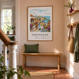 Cartagena Art Print, framed on the wall of a welcoming hallway in a UK terraced house with pale peach plaster walls and plain terracotta floor tiles