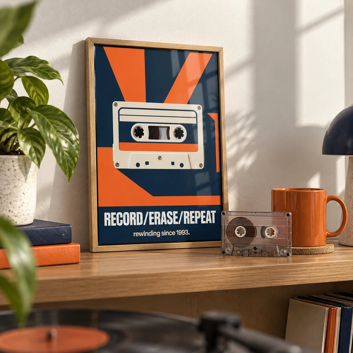 Cassette Tape Wall Art, a small A4 framed print leaning on an oak shelf in a living room